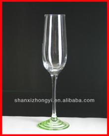 Colored champagne glass with design on  base 