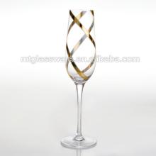 Clear champagne glass with gold swirl